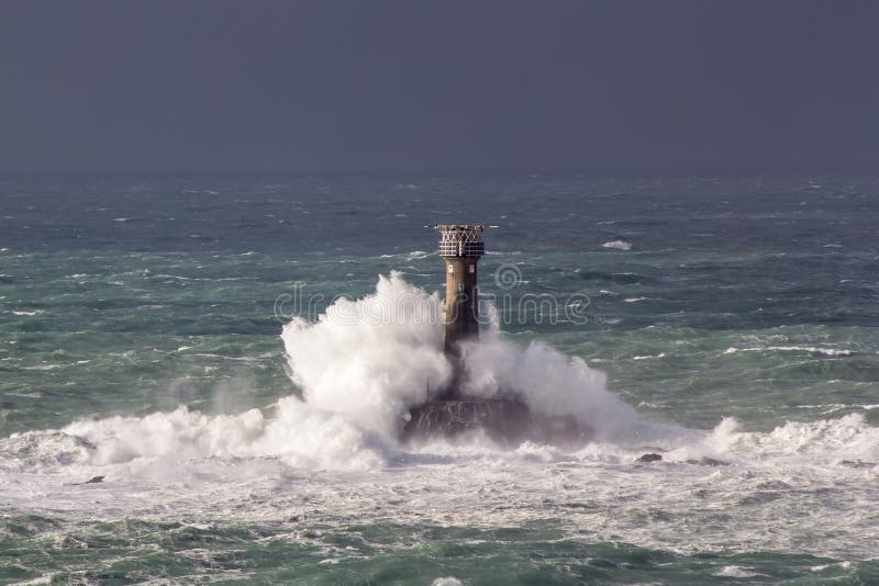 Huge waves crashing Longships Lighthouse photographed from Lands End Cornwall England UK. Huge waves crashing Longships Lighthouse photographed from Lands End Cornwall England UK