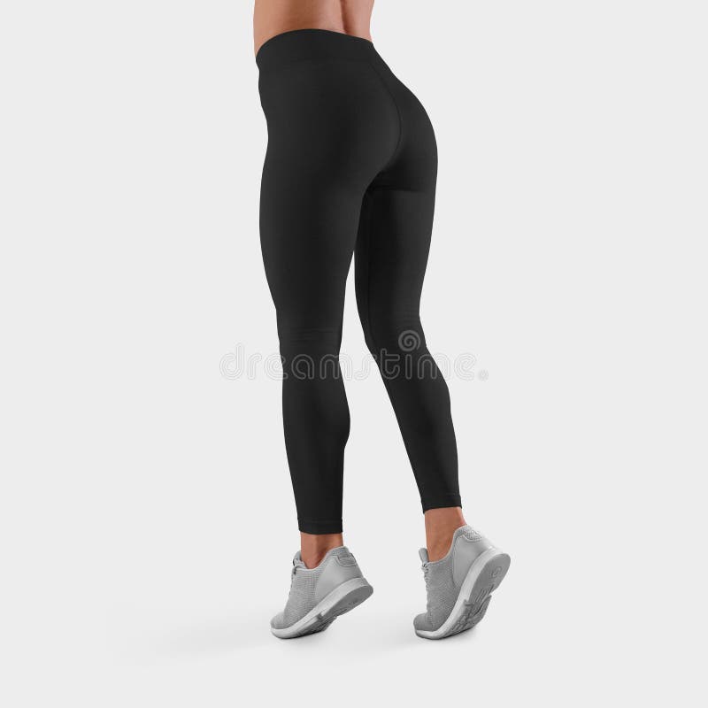 Template of black leggings for fitness and sports on a slender girl standing on toes on a white background in the studio, back