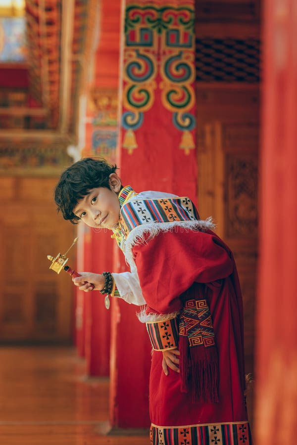 Tibetan boy holding prayer wheel