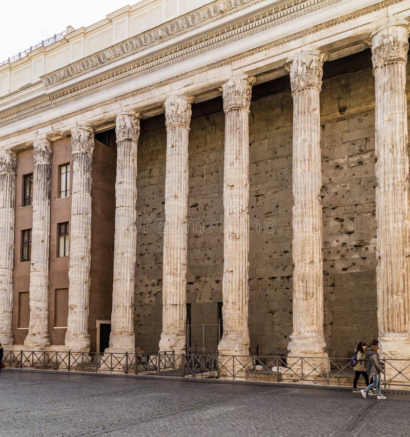 ROME, ITALY - 12TH MARCH 2015: Part of a surving wall on the Temple of Hadrian in Rome. People can be seen. ROME, ITALY - 12TH MARCH 2015: Part of a surving wall on the Temple of Hadrian in Rome. People can be seen.