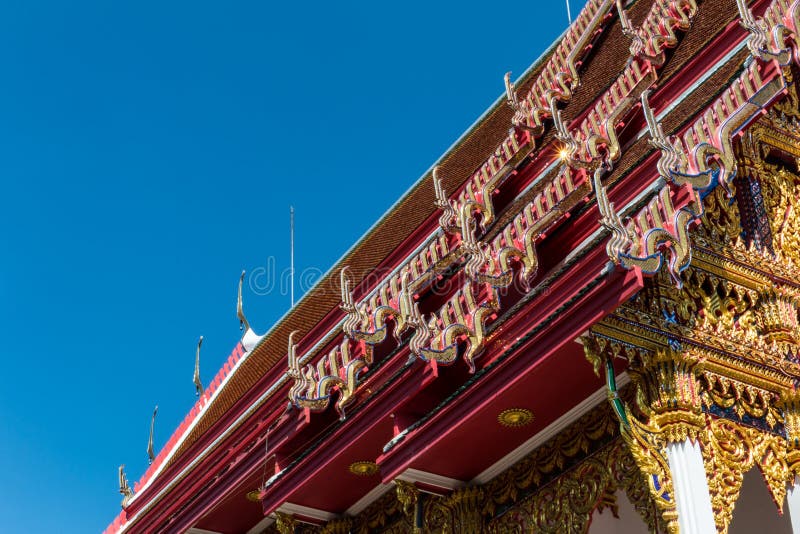 Temple roof vintage Thai style with against blue sky background