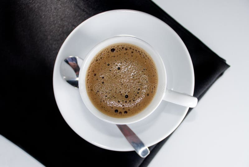 A ceramic cup full of black espresso coffee. A ceramic cup full of black espresso coffee