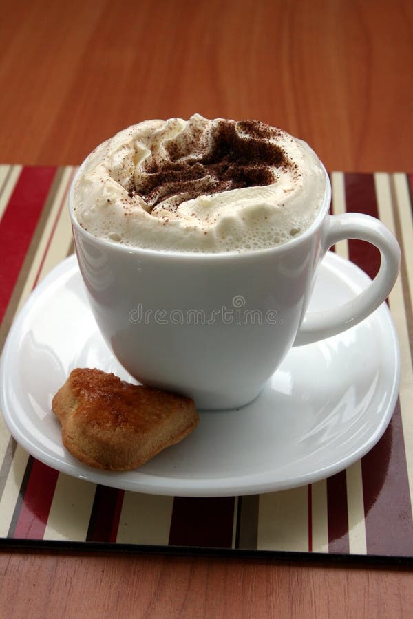 Cup of coffee with whipped cream, chocolate and heart cookie. Cup of coffee with whipped cream, chocolate and heart cookie.