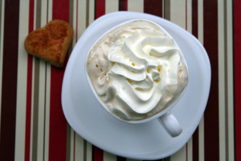 Cup of coffee with whipped cream, chocolate and heart cookie. Cup of coffee with whipped cream, chocolate and heart cookie.