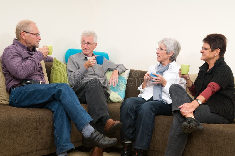 Group of four seniors drinking coffee, chatting and having a great familytime together. Group of four seniors drinking coffee, chatting and having a great familytime together.