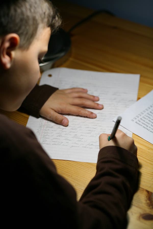 Boys is writing an essay for his homework. Boys is writing an essay for his homework