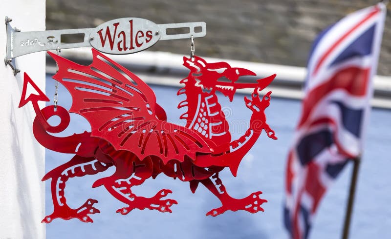 Tenby, Pembrokeshire / Wales UK - 20/8/2019:  traditional red dragon sign hanging from wall