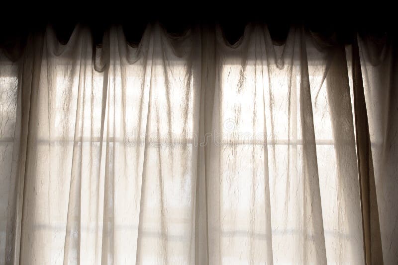 Photograph of Sheer fabric window curtain with filtered light. Photograph of Sheer fabric window curtain with filtered light