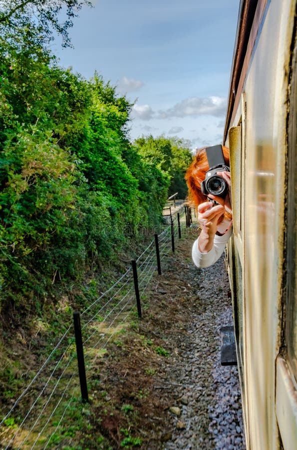Tendenza veduta fotografia della donna da una finestra commovente del treno passeggeri per prendere una fotografia fotografia stock Tendenza veduta fotografia della donna da una finestra commovente del treno passeggeri per prendere una fotografia fotografia stock
