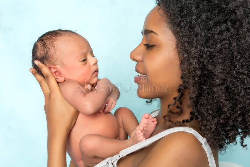 Tender African mother holding her 11 days old newborn baby. Tender African mother holding her 11 days old newborn baby