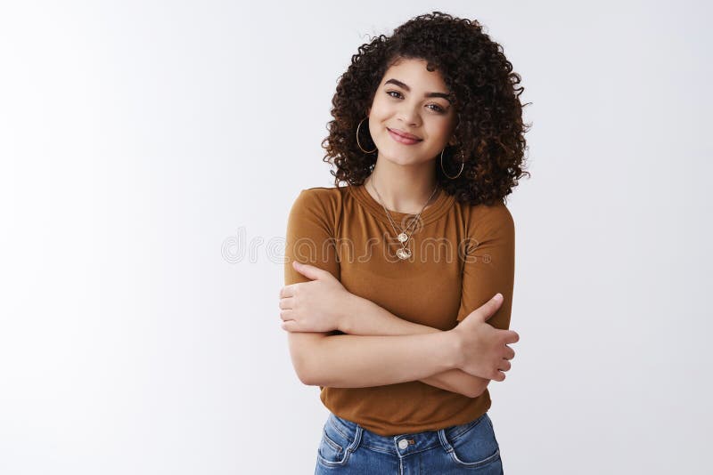 Tender attractive young alluring curly-haired nice girl smiling feel warmth care hugging herself standing comfort