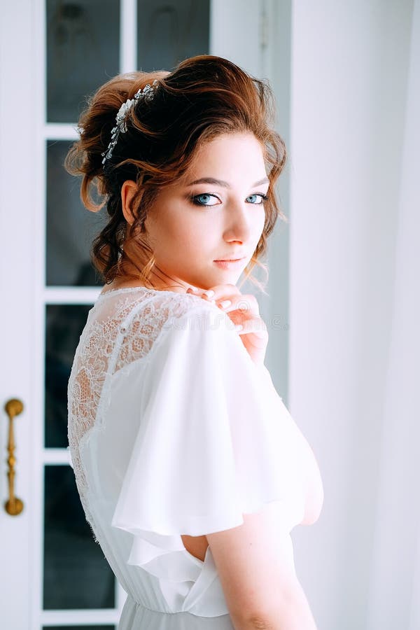 Tender Elegant Young Bride with Hairdo, Hairpin and Bridal Makeu