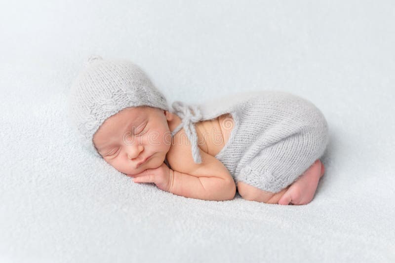 Tender newborn sleeping on belly stock photo Tender newborn sleeping on belly stock photo