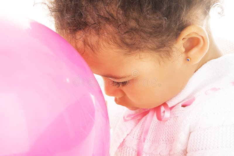 Tender little girl with a pink balloon