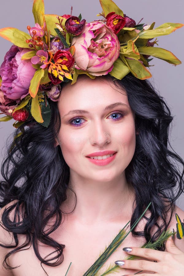 Tender Young Woman Posing in Flower Wreath with Art photo photo