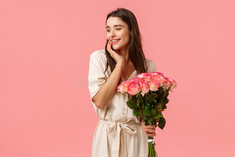 Tenderness, women and beauty concept. Attractive sensual young girl receive beautiful bouquet flowers, holding roses