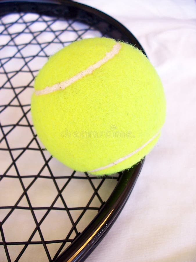 Close up photo of tennis ball and racket.