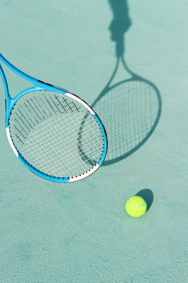 Tennis Ball and Racket on Blue Hard Tennis Court. Shadow of a Hand ...