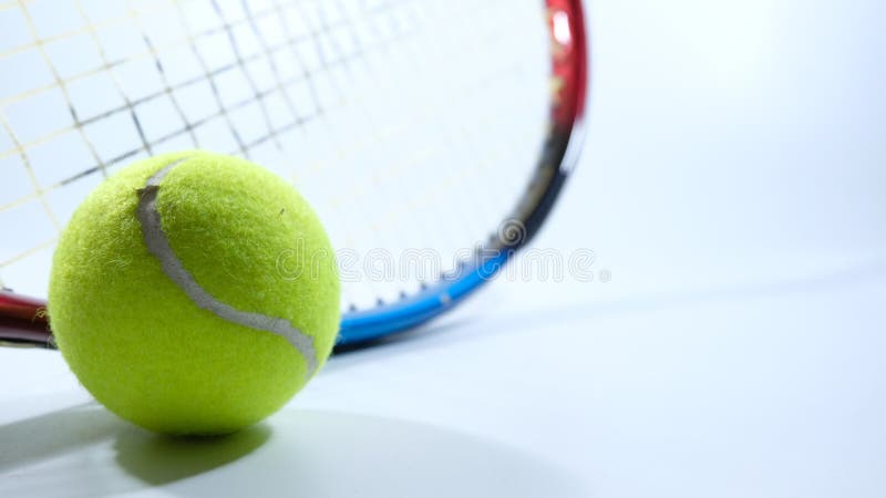 Tennis ball and racket over white background stock photography Tennis ball and racket over white background stock photography