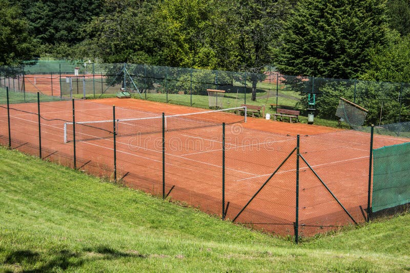 Tennis court on red sand stock image. Image of sand 187420725