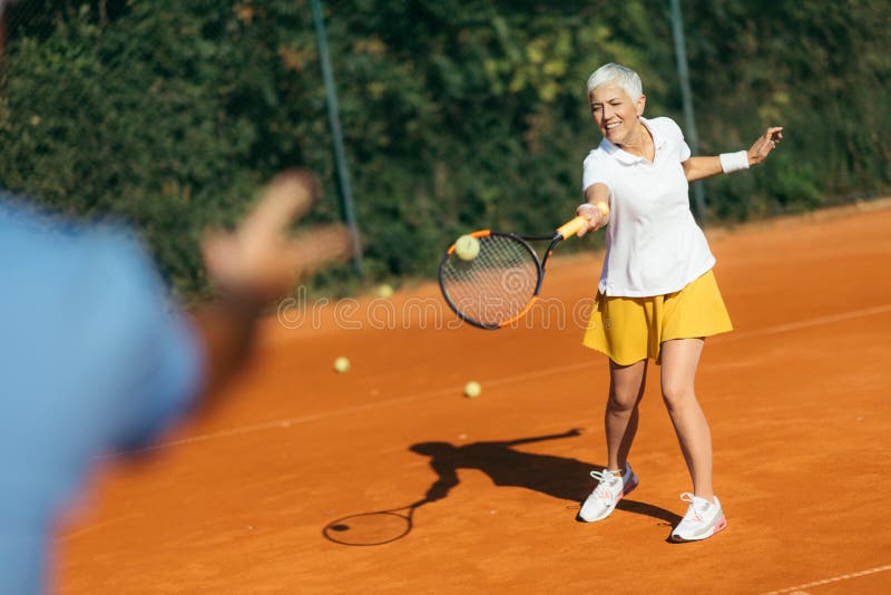 Tennis Instructor with Senior Woman, Tennis Training Lesson Stock Image