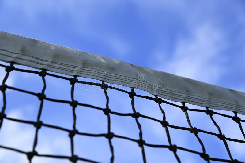 Tennis net and blue sky as background