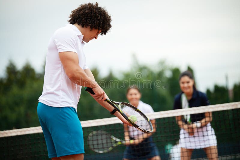 Tennis Player Prepares To Serve Ball during Tennis Match Stock Image