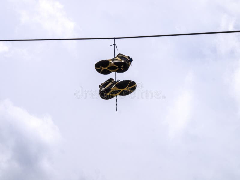 Tennis shoes hanging from a power line