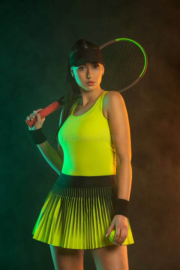 Tennis player with racket. Download a photo of a tennis player in a neon glow to advertise sporting events. Sports betting online in a mobile application. Tennis player with racket. Download a photo of a tennis player in a neon glow to advertise sporting events. Sports betting online in a mobile application