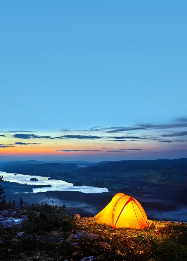 A tent lit up at dusk