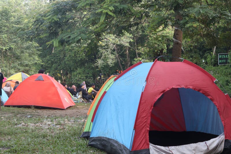Tents in a Field with Trees in the Background Stock Image Image of