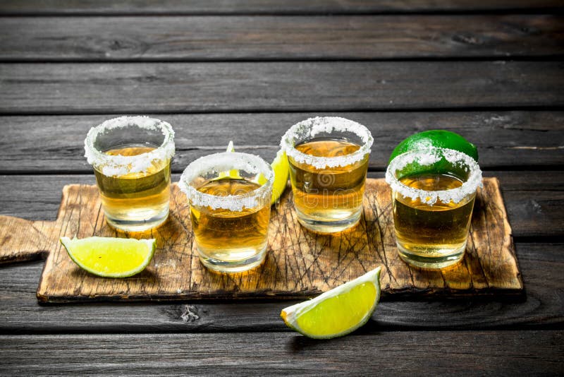 Tequila in a Shot Glass on a Cutting Board with Slices of Lime Stock ...