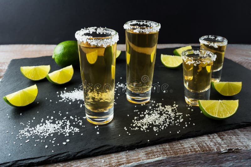 Tequila Shots with Lime on Black Stone Background Stock Photo - Image ...