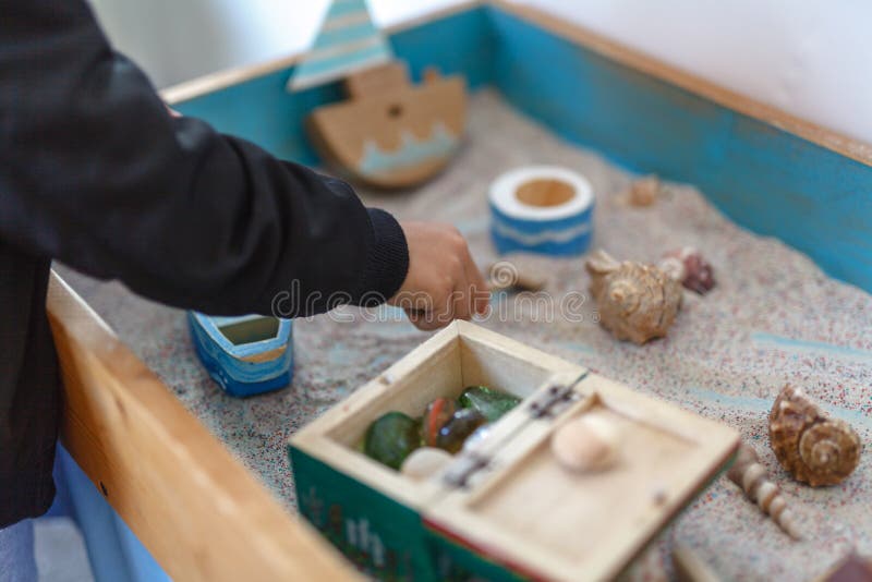 Sand therapy. The child is built in a sandbox world. Sand therapy. The child is built in a sandbox world