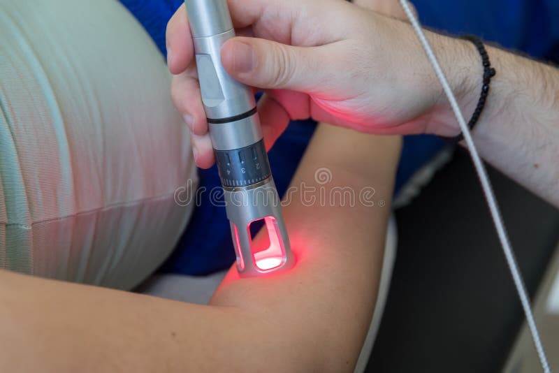 Laser therapy in hand used to treat pain. selective focus. Laser therapy in hand used to treat pain. selective focus