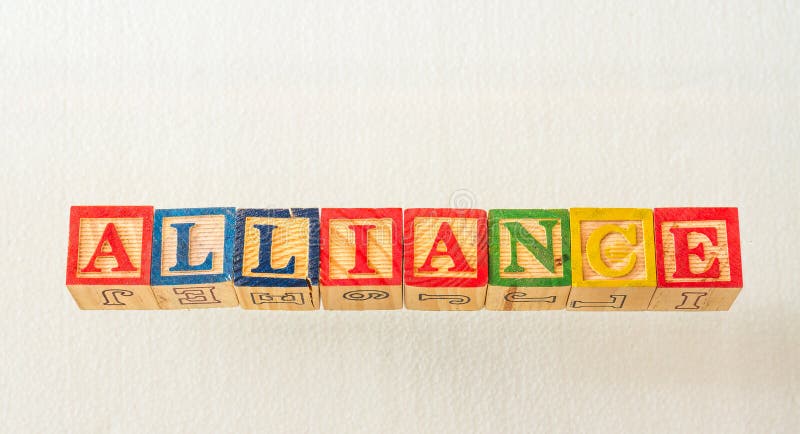 The term alliance displayed visually. The term alliance visually displayed on a white background using colorful wooden blocks image with copy space in landscape format
