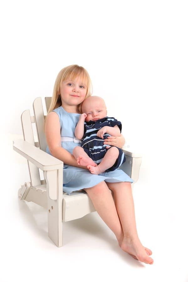 Big Sister Holding Her Newborn Baby Brother on White. Big Sister Holding Her Newborn Baby Brother on White