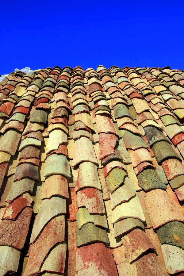 Terracotta roof on blue summer sky