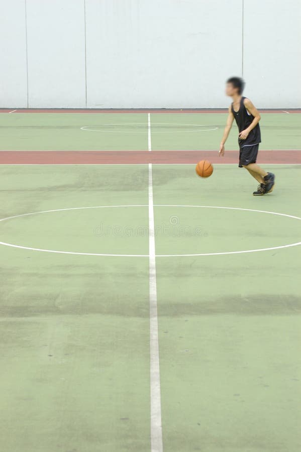 Basketball court in muted tones. player with slight motion blur. Basketball court in muted tones. player with slight motion blur