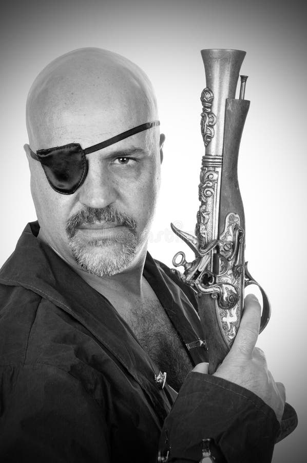 Terrible bearded pirate with a musket stock image