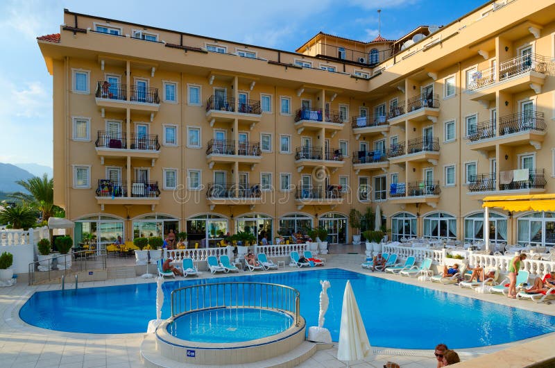 CAMYUVA, TURKEY - SEPTEMBER 21, 2022: Unidentified people are relaxing near pool in territory of four-star Sinatra hotel, Camyuva, Kemer, Turkey. CAMYUVA, TURKEY - SEPTEMBER 21, 2022: Unidentified people are relaxing near pool in territory of four-star Sinatra hotel, Camyuva, Kemer, Turkey