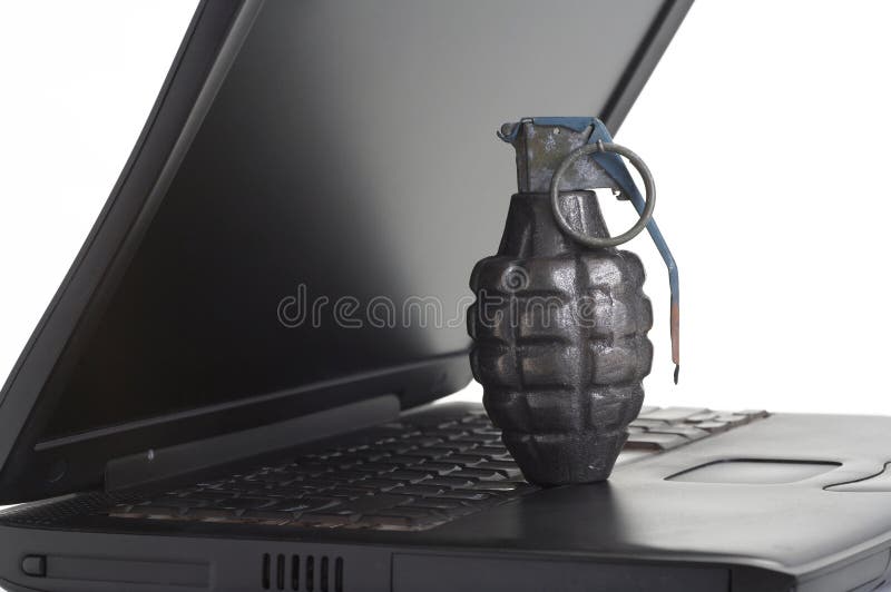 Computer terrorism concept, grenade on laptop keyboard. Computer terrorism concept, grenade on laptop keyboard