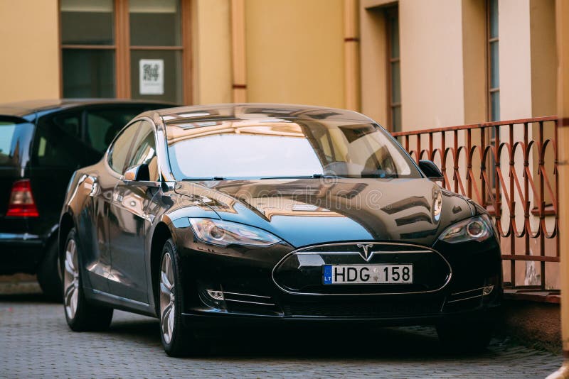 Tesla Model S Car In Motion On Street. The Tesla Model S Is A Full-sized All-electric Five-door, Luxury Liftback