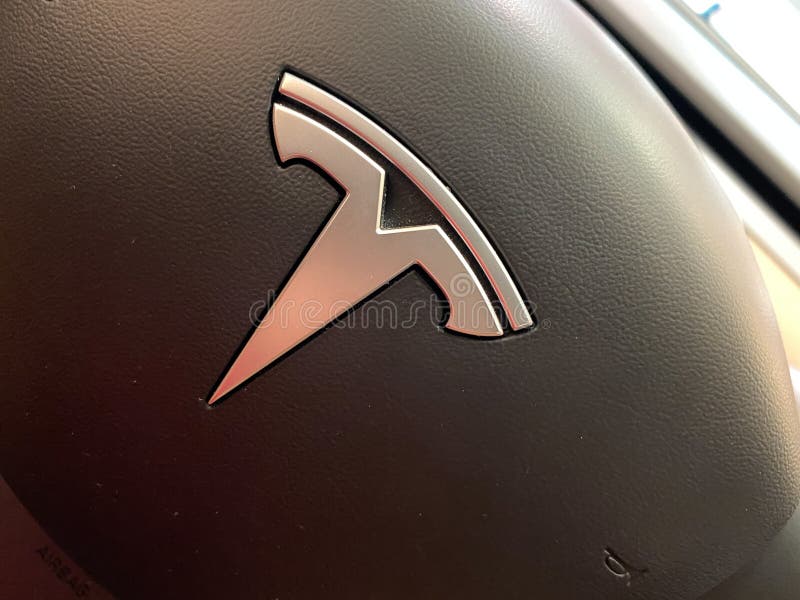 A Tesla Model 3 steering wheel at a Tesla retail store