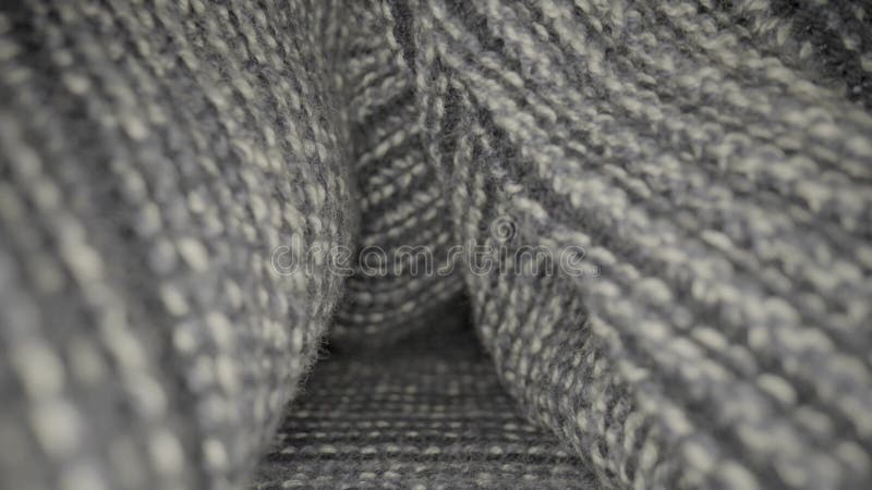 Tessuto di lana grigia a maglia. struttura di maglioni di indumenti tiepidi, padella, sciarpa. morbido a maglia