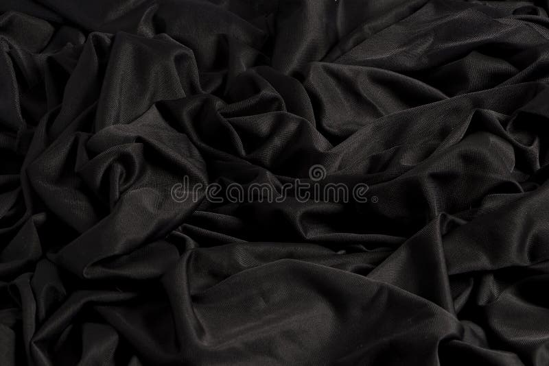 Tessuto nero luminoso con le ondulazioni e la struttura con luce dura e luce scura fotografie stock libere da diritti Tessuto nero luminoso con le ondulazioni e la struttura con luce dura e luce scura fotografie stock libere da diritti