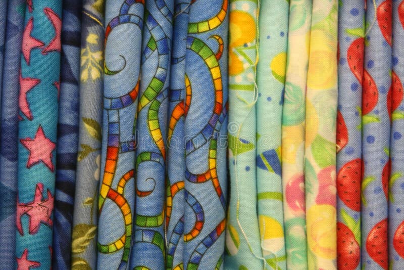 Close up of bold colorful bolts of quilt fabric. Close up of bold colorful bolts of quilt fabric