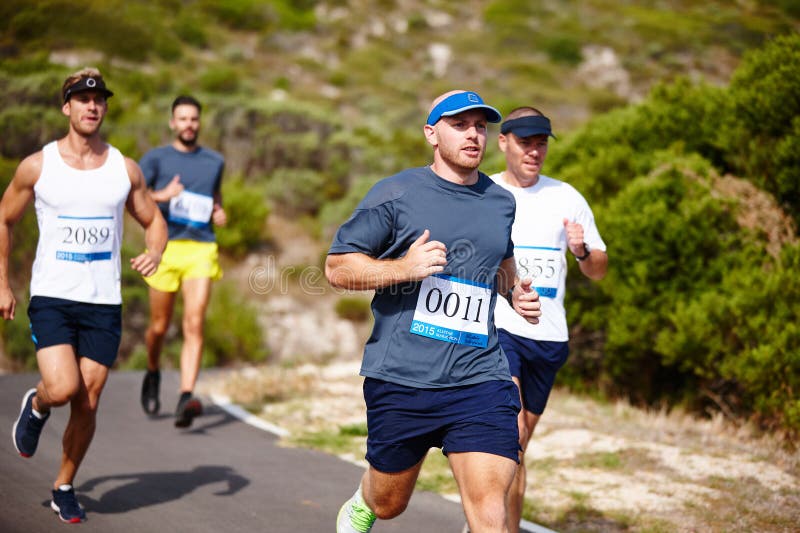 Test of Endurance. a Group of Young Men Running a Marathon. Stock Image