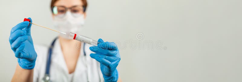 Test for coronavirus Covid-19. Female doctor or nurse doing lab analysis of a nasal swab in a hospital laboratory. Medical technologist holding a COVID-19 smear kit, wearing protective gloves from. Test for coronavirus Covid-19. Female doctor or nurse doing lab analysis of a nasal swab in a hospital laboratory. Medical technologist holding a COVID-19 smear kit, wearing protective gloves from