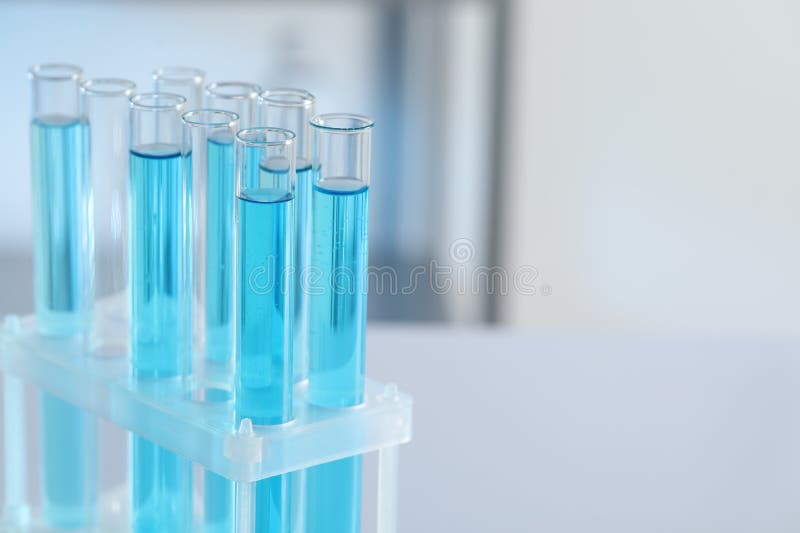 Test Tubes with Light Blue Liquid in Laboratory, Closeup. Space for